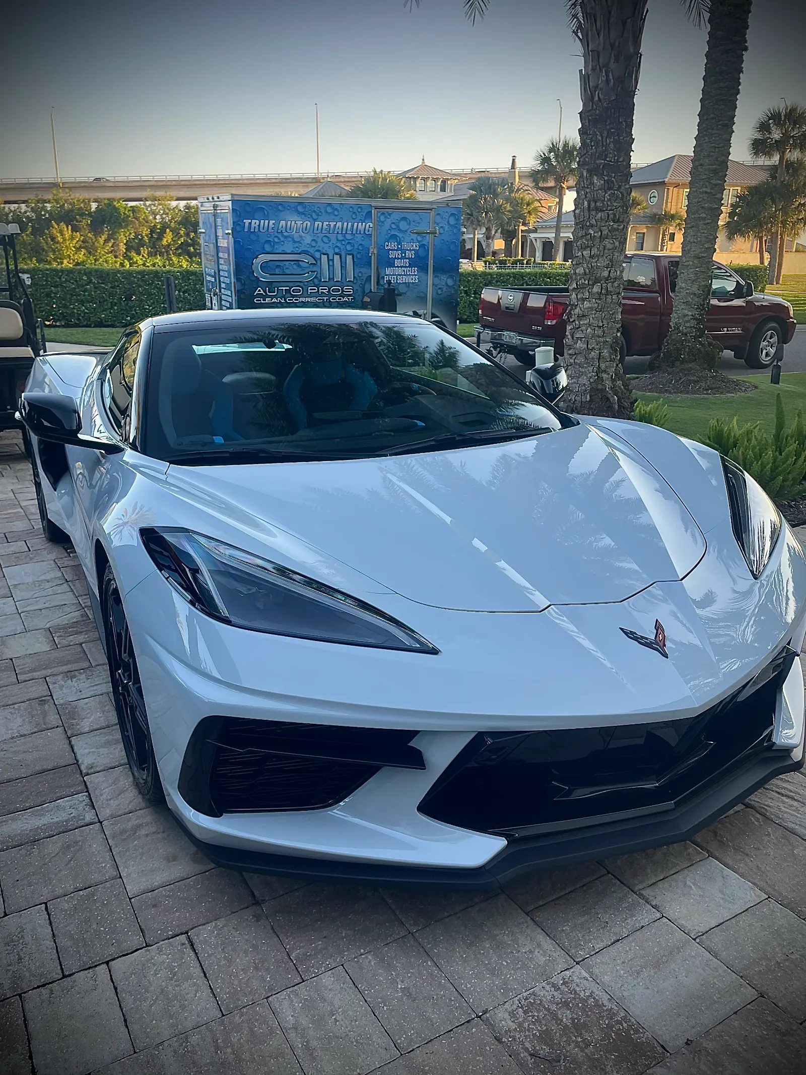 Professional mobile car detailing Jacksonville FL - freshly detailed Corvette in driveway with C3 Auto Pros mobile detailing truck